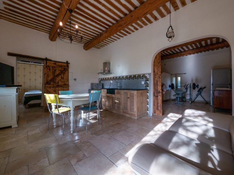 Intérieur d'un gite avec cuisine équipée, salle à manger et mobilier moderne.